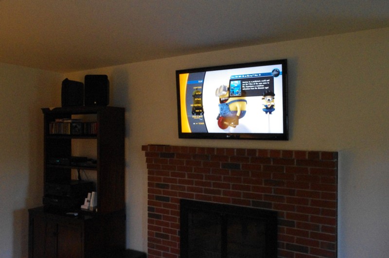 TV Mounted over brick fireplace